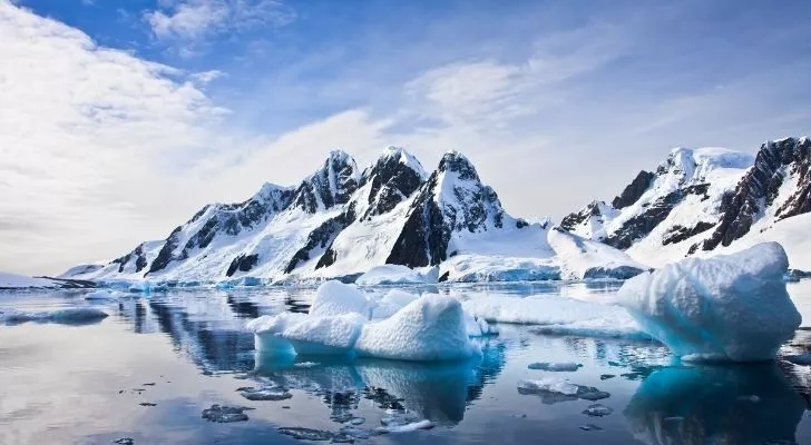 Antarctica landscape of snowy mountains and icebergs 