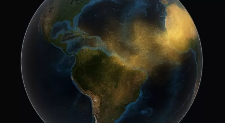 A map of earth showing sand sweeping across the seas from the Sahara to the Amazon Rainforest