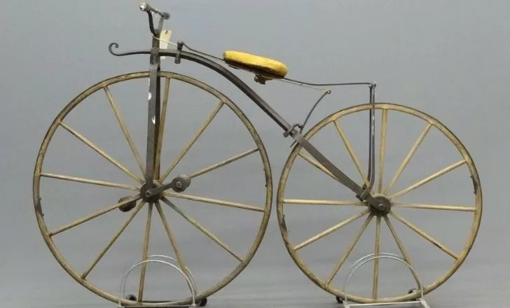 A golden boneshaker bicycle