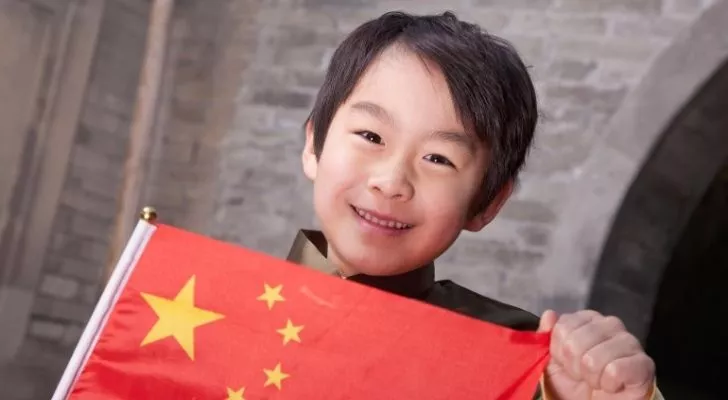 A Chinese boy holding a flag of China