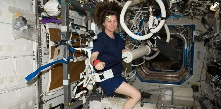 An astronaut working out in zero gravity