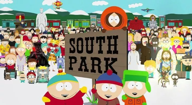 The four South Park boys in front of the South Park Sign, with the show's most iconic characters in the background.