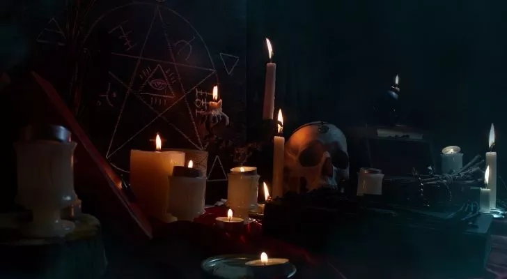 Various witchcraft items like candles and a skull